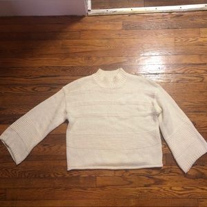A cream colored sweater from Lush